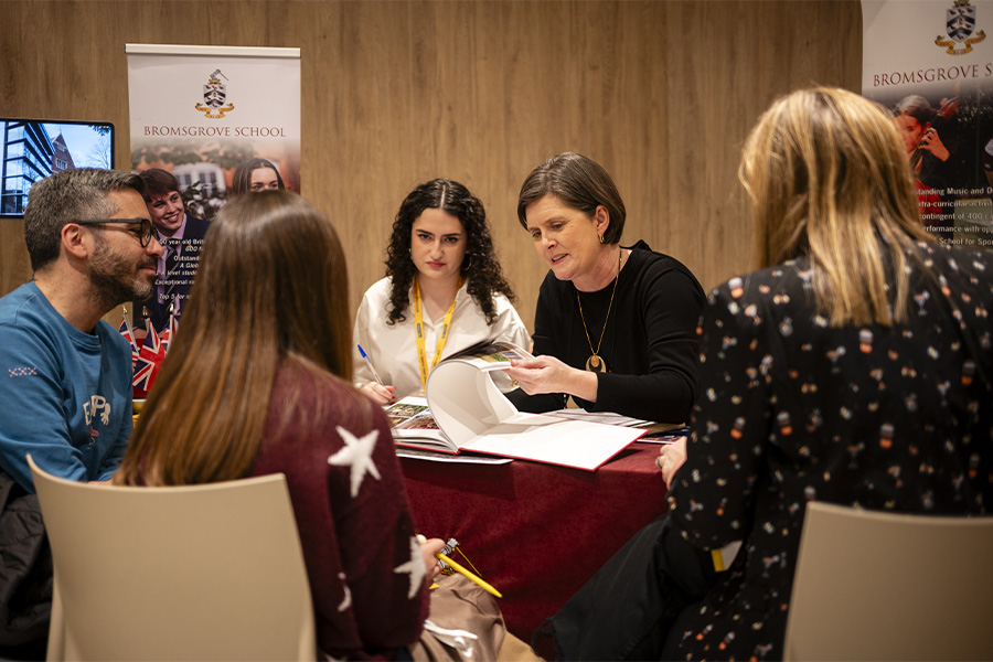 Representante de colegio británico hablando con familias interesadas en su programa para estudiantes internacionales