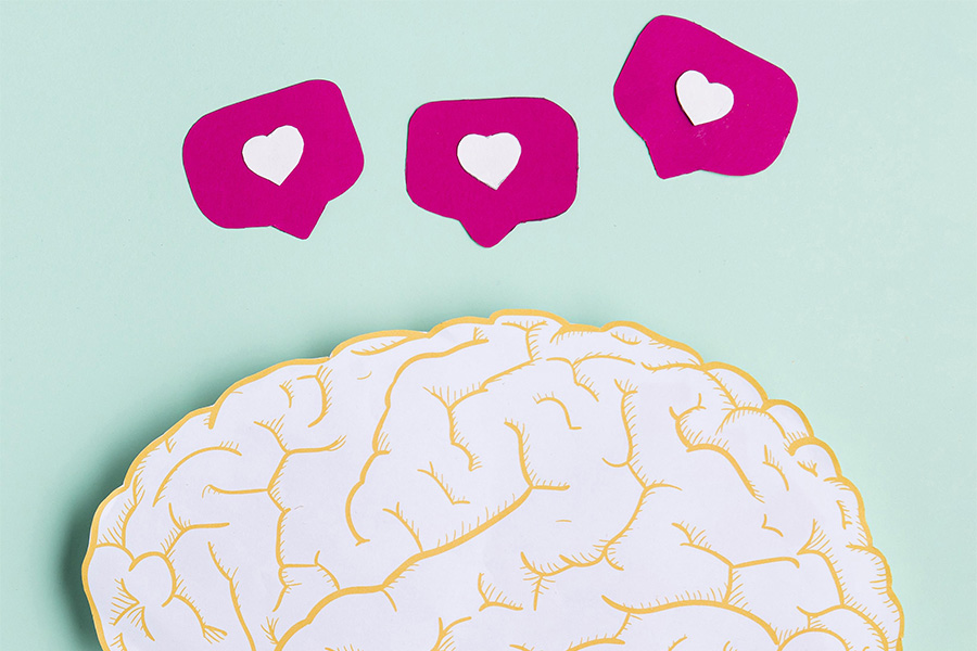 Ilustración de un cerebro con notificaciones de corazones, simbolizando la liberación de sustancias de bienestar.